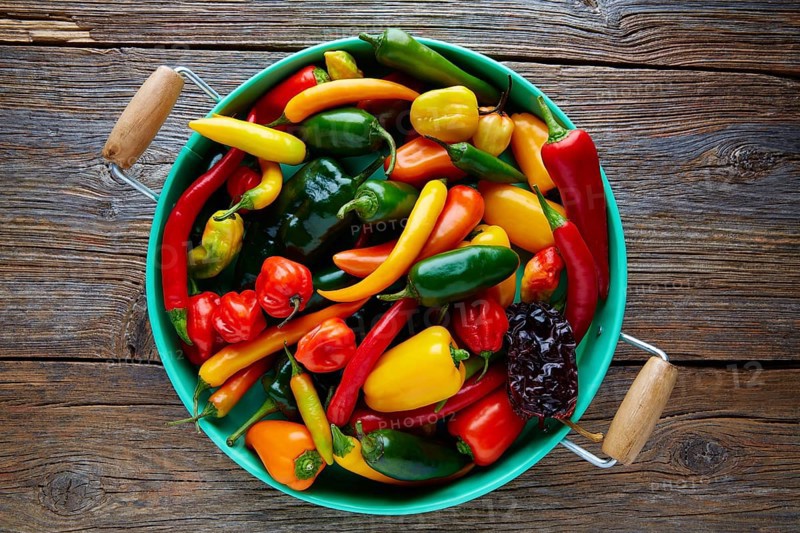 Mexican hot chili peppers colorful mix habanero poblano serrano jalapeno on wood