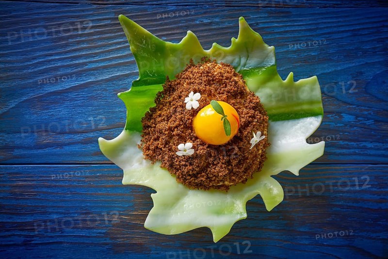 Modern cuisine ice cream with orange spherification and crispy caramelized cookie