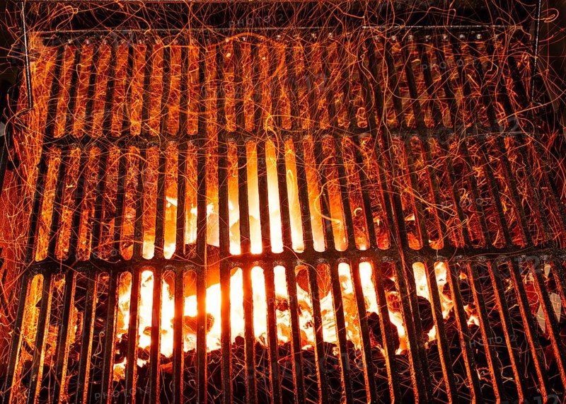 Bar-b-cue grill barbecue with red ashes and sparkles in fire