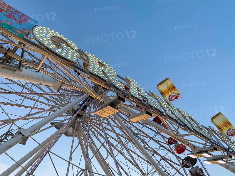Ferris wheel, bottom view of a ferris wheel against the blue sky. San Diego County Fair, California, USA. July 13th