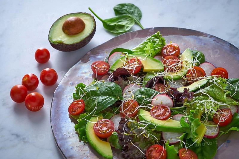 Avocado salad with sprouts tomatoes spinach and radish healthy food