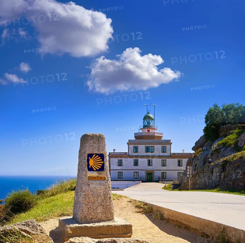 End of Saint James Way sign and lighthouse of Finisterre in Galicia Spain photomount