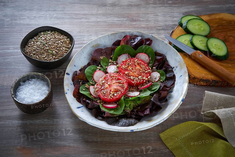 Tomato salad with seeds radish spinach and lettuces healthy food