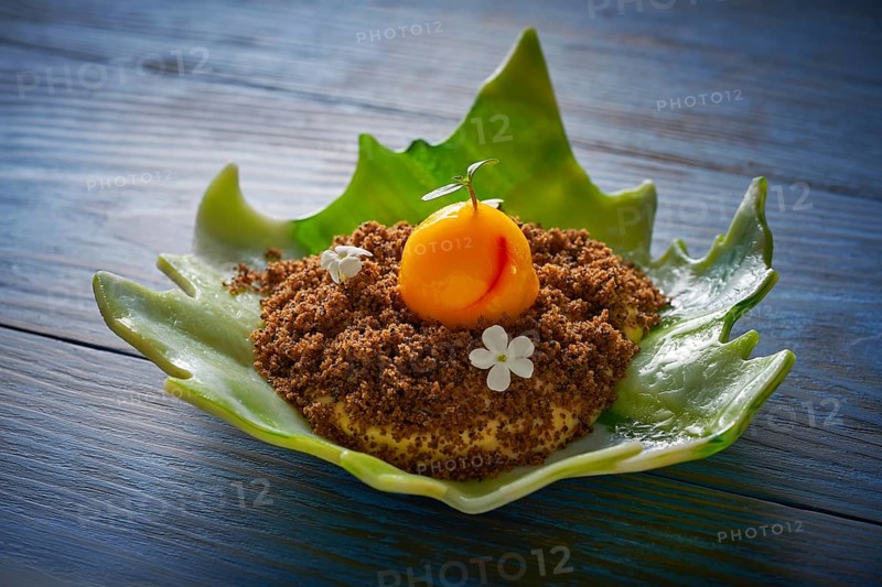 Modern cuisine ice cream with orange spherification and crispy caramelized cookie
