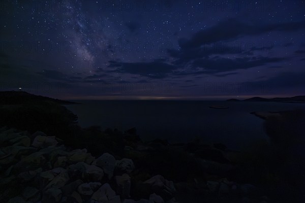 Clear starry sky over a dark coastal landscape at night, Milky Way, Lastovo, Neretva, Croatia, Europe