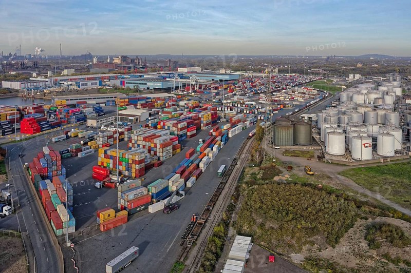 Commercial port with container terminal and oil tanks at the Rhine river in North Rhine-Westphalia, Germany, Europe