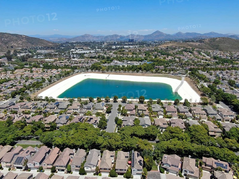 Aerial view of water recycling reservoir surrounded by suburban neighborhood in San Diego County, California. USA