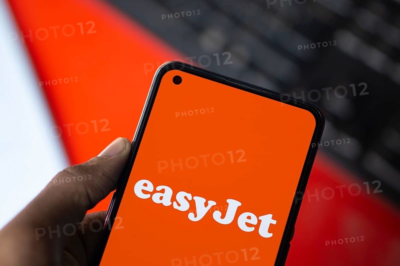 EasyJet logo is displayed on smartphone. EasyJet plc is a British multinational low cost airline group.