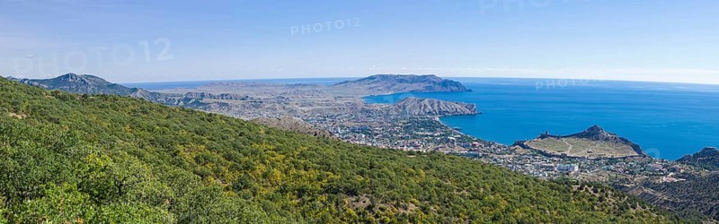 Panorama of the Black Sea coast, a view from the Perchem mountain on the resort town of Sudak and Kapselsky bay. Crimea. Sunny day in September