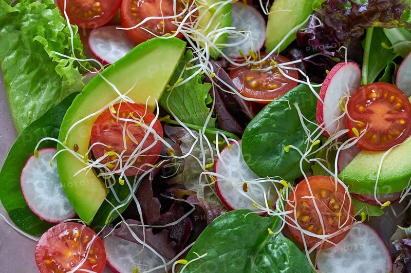 Avocado salad with sprouts tomatoes spinach and radish healthy food