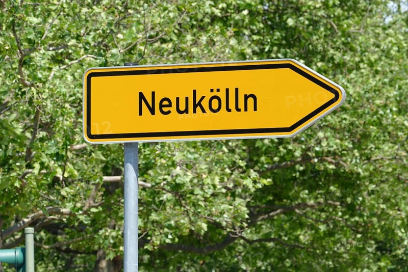 Street sign with the inscription: Newkölln (Neukölln), the district of the same name in Berlin