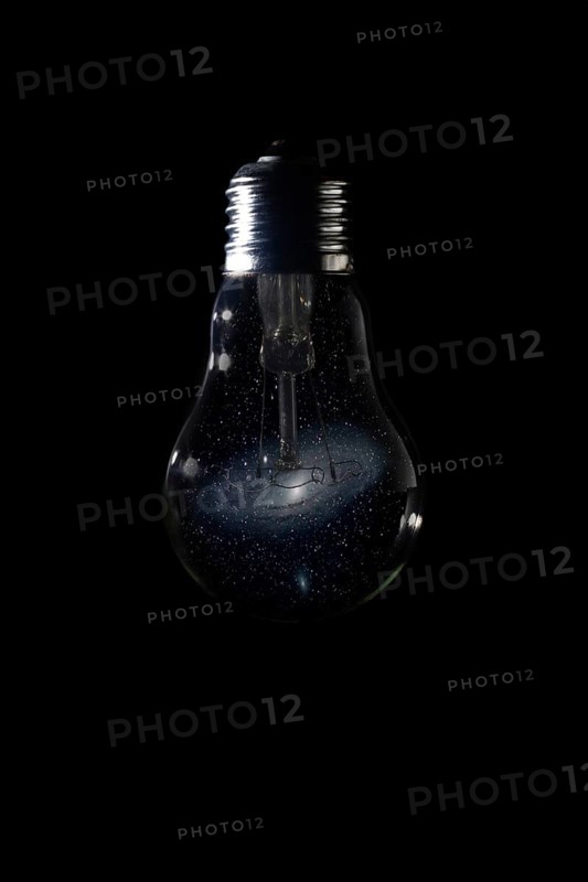 Andromeda Galaxy inside of light bulb on dark background Andromeda Galaxy Messier 31