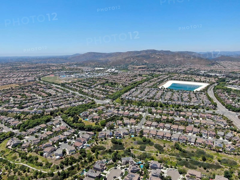Aerial view of water recycling reservoir surrounded by suburban neighborhood in San Diego County, California. USA
