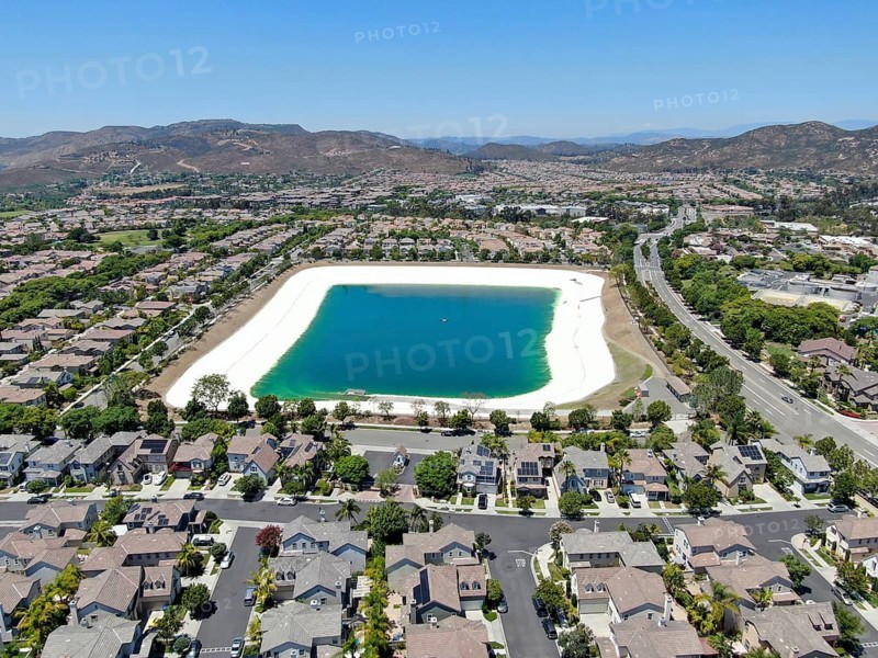 Aerial view of water recycling reservoir surrounded by suburban neighborhood in San Diego County, California. USA