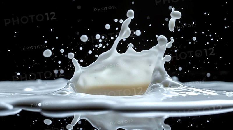 Milk splash with droplets suspended in the air against a dark background, creating a dynamic motion effect, AI generated