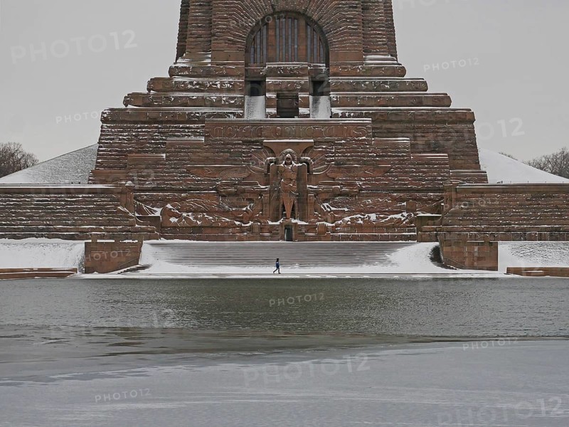 Lonely hiker at the wintry Völkerschlachtdenkmal. Leipzig, Saxony, Germany, Europe