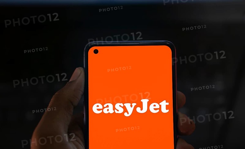 EasyJet logo is displayed on smartphone. EasyJet plc is a British multinational low cost airline group.