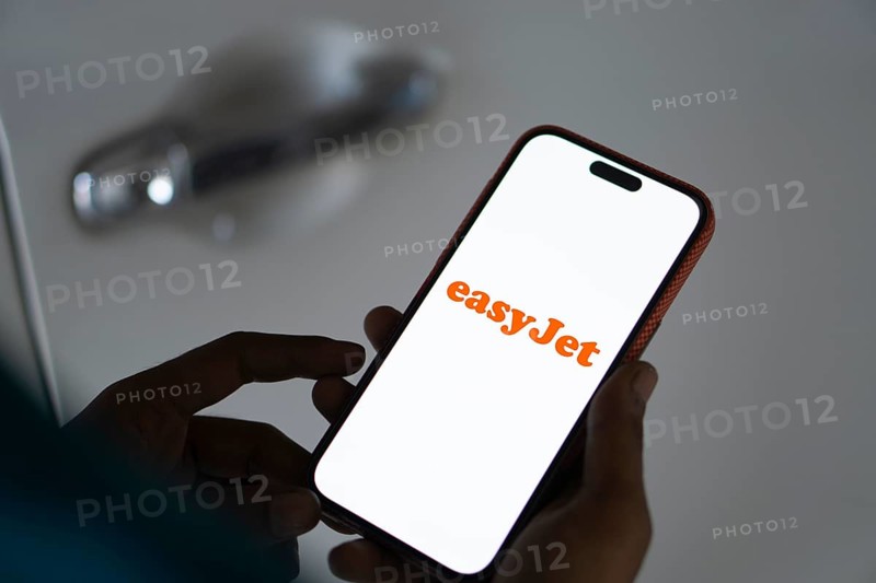 EasyJet logo is displayed on smartphone. EasyJet plc is a British multinational low cost airline group.