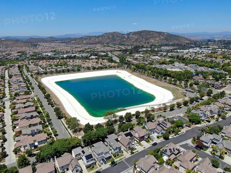 Aerial view of water recycling reservoir surrounded by suburban neighborhood in San Diego County, California. USA