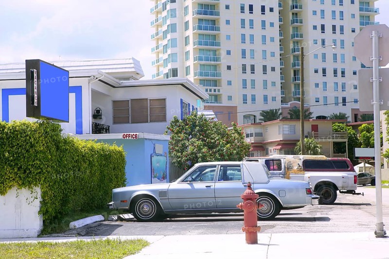 Miami beach casual coast city view with cars and buildings
