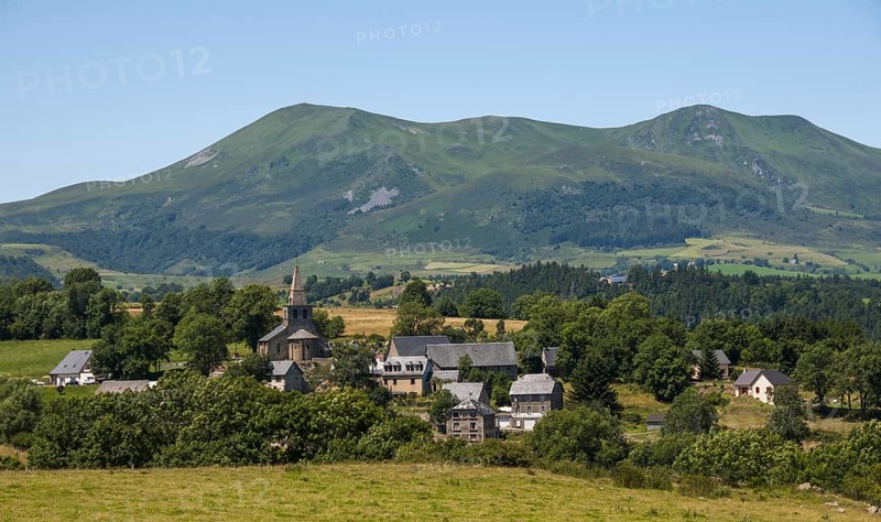 Scenic view of Saint Victor la Riviere village in Auvergne with Mont Dore mountains in the background on a clear day, Puy de Dome. Auvergne.France