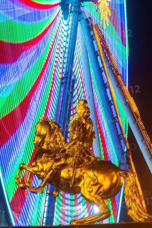 Augustus Market in Dresden. Equestrian statue of Augustus the Strong, also known as the Golden Horseman, with a Ferris wheel turning behind it, Dresden, Saxony, Germany, Europe