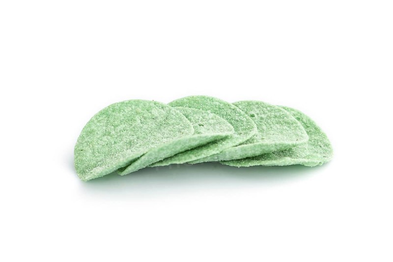 Green potato chips isolated on white background. Side view, close up