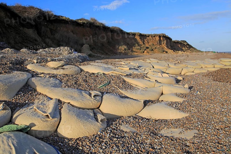 Sacks containing shingle form coastal defences at Thorpeness, Suffolk, England, UK