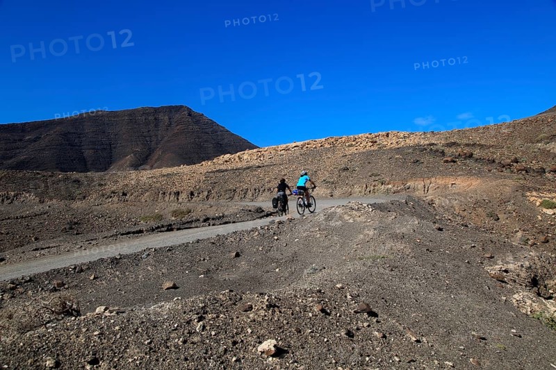 Cycling in barren landscape of Jandia peninsula Fuerteventura, Canary Islands, Spain, Europe