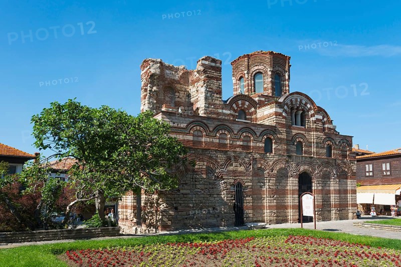 Old crumbling brick ruins under a clear blue sky surrounded by green vegetation and colourful flower beds, Christ Pantocrator Church, Cross Dome Church, Black Sea, Nesebar, Nessebar, Burgas, Bulgaria, Europe