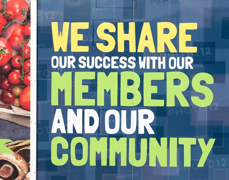 We Share Our Success With Our Members and Our Community, East of England Co-operative Society shop advertising boards hoardings, Woodbridge, Suffolk, UK