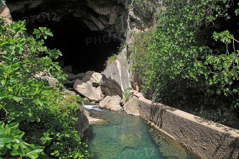 Person exploring entrance ot cave, Cueva del Gato, Benaojan, Serrania de Ronda, Malaga province, Spain, Europe