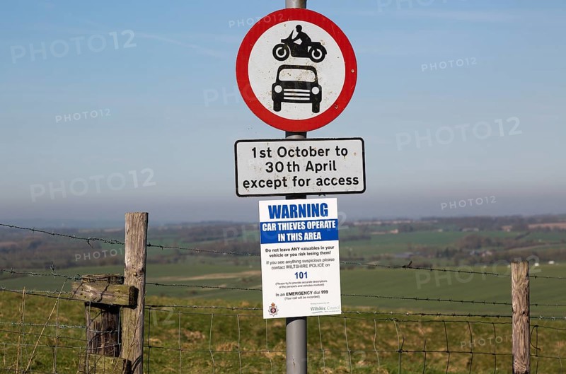 Road signs and car thieves warning sign, Ridgeway at Hackpen Hill, Wiltshire, England, UK
