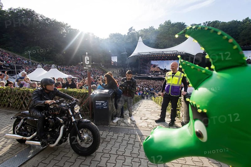 Peter Maffay rides past Tabaluga on his Harley Davidson in front of his concert on We Love Rock 'n' Roll, Farewell Tour 2024 at the Waldbühne in Berlin on 4 July 2024