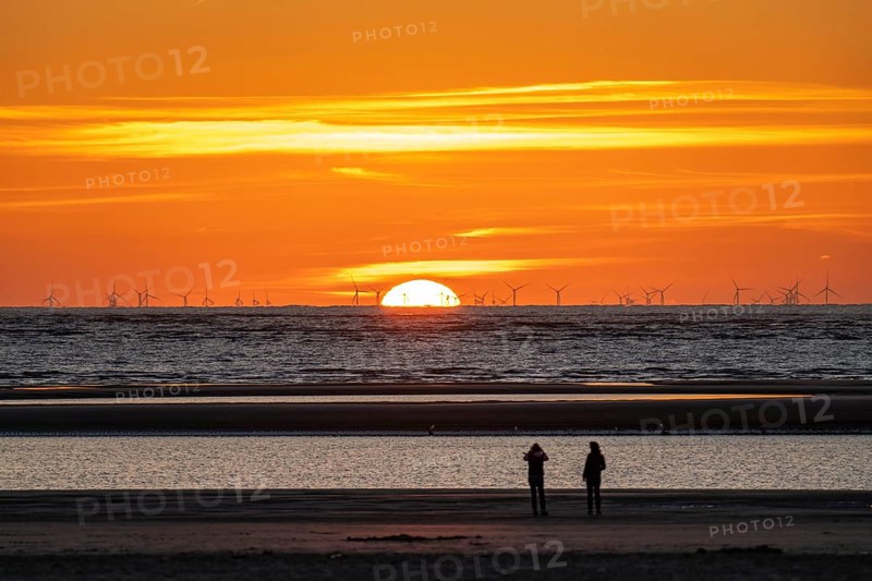 North Sea island of Langeoog, early summer, shortly after the first easing of the lockdown in the Corona crisis, still quite few tourists on the beach, offshore wind farm, sunset, Lower Saxony, Germany, Europe