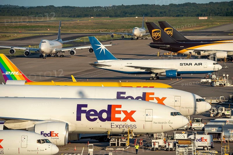 Cologne-Bonn Airport, CGN, cargo aircraft standing in front of the air cargo centre, being loaded and unloaded, UPS cargo jumbo jet taxiing for take-off, one just landed, Jumbo, North Rhine-Westphalia, Germany, Europe