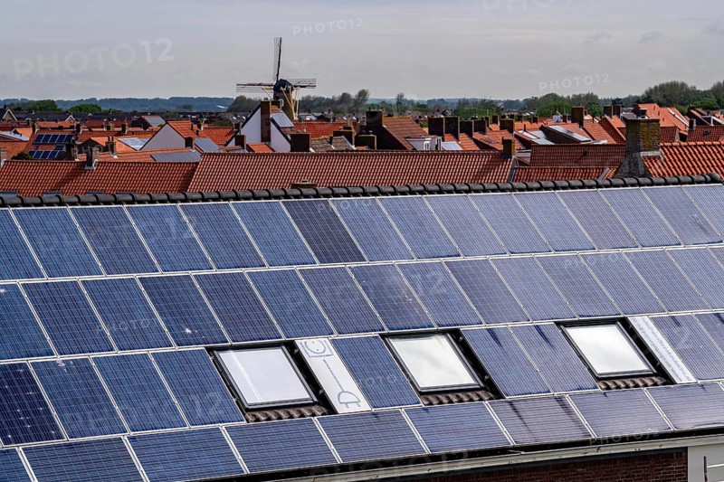 Solar modules on roofs, on the roof of a building on the dyke, North Sea coast, in Zeeland, Westkapelle, Netherlands