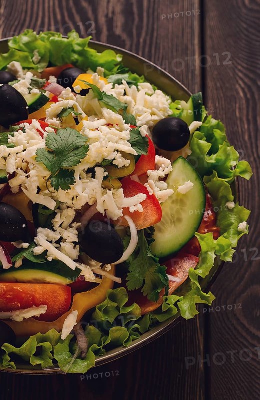 Traditional Bulgarian dish, Shopska salad, on a wooden table, salad of fresh vegetables, top view, close-up, no people, Bulgarian food, Bulgarian cuisine, salad, vegetables