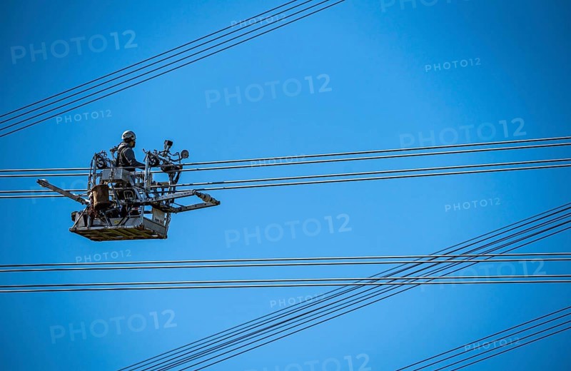 Construction of a new line route, 380 KV extra-high-voltage line between Osterath and Gohr, near Neuss, fitters in line trolleys, on the conductor cables, installing field spacers at great heights, North Rhine-Westphalia, Germany, Europe