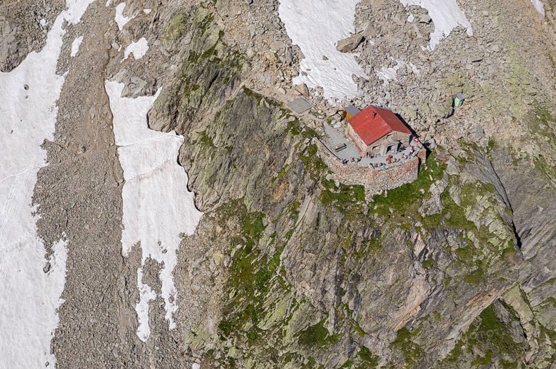 Aerial view of mountain hut Cabane de l'A Neuve, located on a steep rock formation, near La Fouly, Val de Ferret, Switzerland, Europe