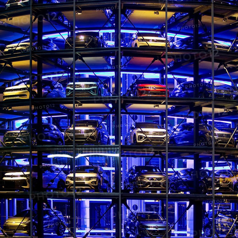An illuminated car tower with new cars for delivery in the evening, detail, Autostadt, Volkswagen AG, Wolfsburg, Lower Saxony, Germany, Europe