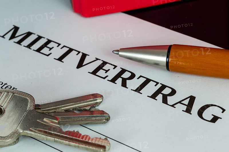 Symbolic image of rental agreement: close-up of a rental agreement and front door key