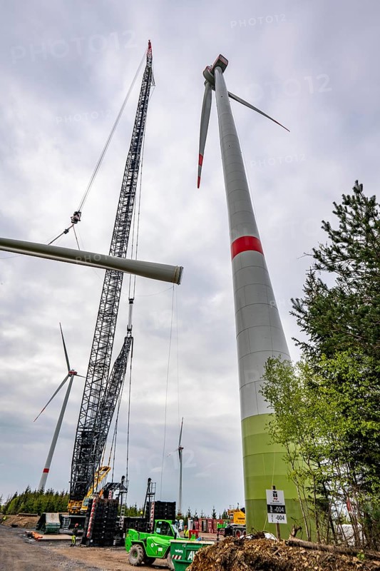 Erection of a wind turbine, wind energy plant, assembly of the third blade, with a crawler lattice crane, wind farm near Hagen, North Rhine-Westphalia, Germany, Europe