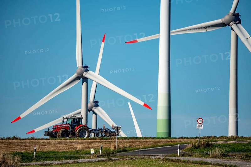 Wind farm near Lichtenau, wind turbines, country road, Driburger Straße, tractor at work in the field, North Rhine-Westphalia, Germany, Europe
