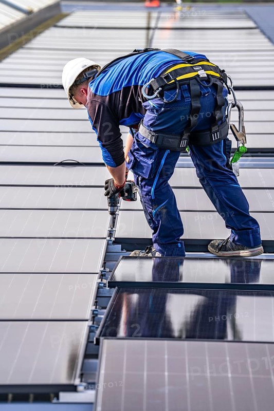 Installation of solar modules on the roof of a commercial enterprise, over 400 photovoltaic modules are installed on the roof, North Rhine-Westphalia, Germany, Europe