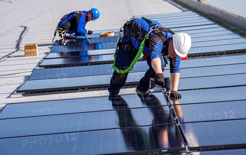 Installation of solar modules on the roof of a commercial enterprise, over 400 photovoltaic modules are installed on the roof, North Rhine-Westphalia, Germany, Europe