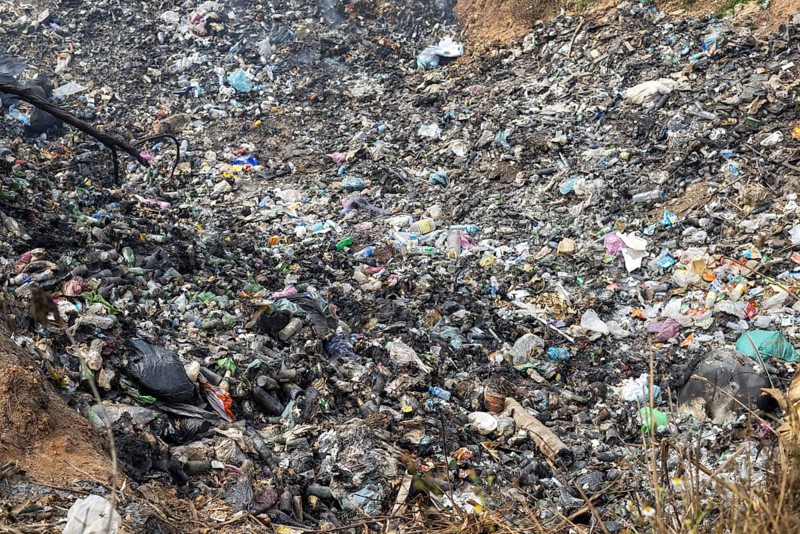 Coking rubbish dump, rubbish pit with waste and plastic rubbish, karst landscape near Vang Vieng, Vientiane province, Laos, Asia