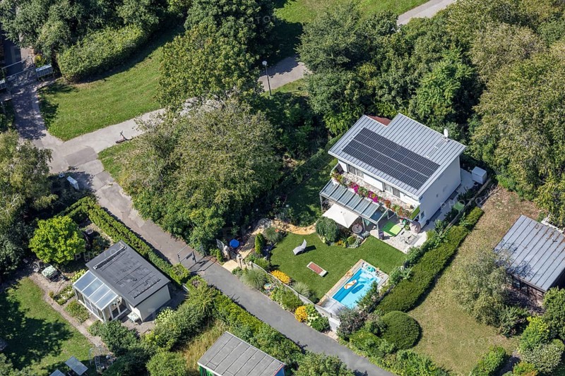 Aerial view of a modern house with garden, pool and solar panels on the roof, Vienna