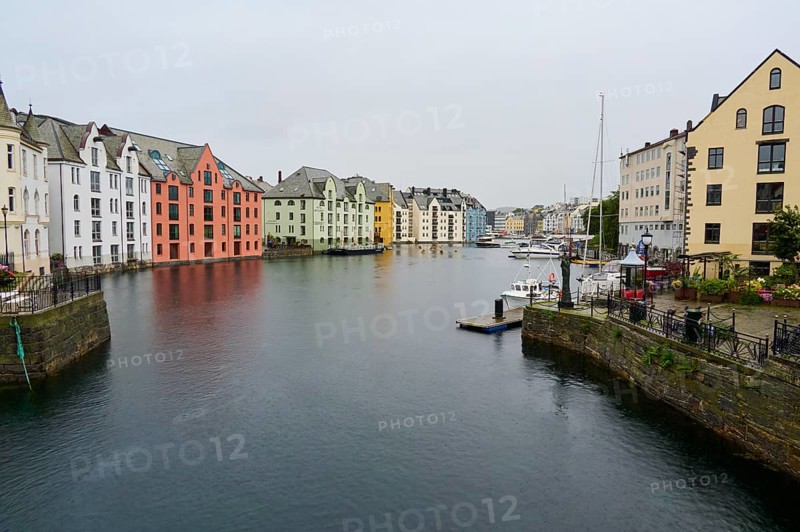 City view with coloured buildings by the sea, boats and bridge in the background, Alesund, Fylke, Norway, Europe