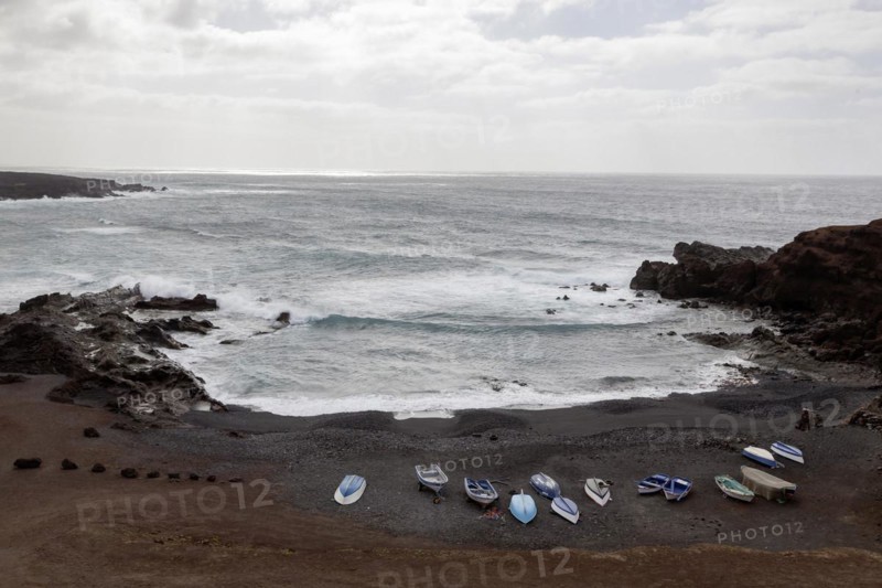 Fishing boats on the black beach of El Golfo, volcanic crater, cloudy sky, Lanzarote, Canary Islands, Spain, Europe